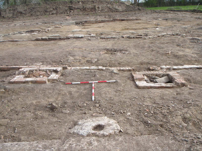 Structure E with two drain junction boxes and a fence posthole