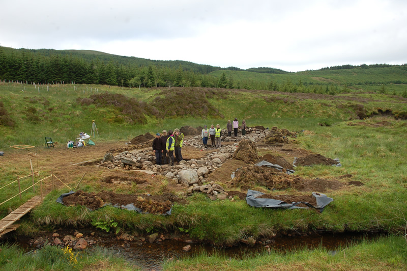 Overview of Tigh Caol with volunteers at East gable, central hearth and western room